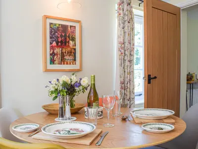 a dining room table with plates and wine glasses at The Bothy - Uk33692 in Bicton