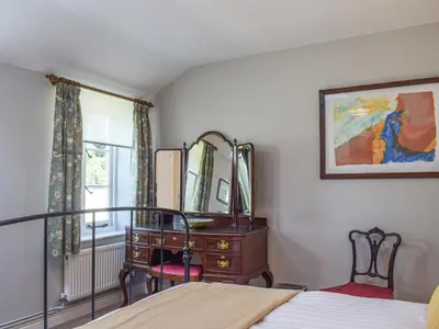 a bedroom with a dresser and a desk and a window at The Bothy - Uk33692 in Bicton