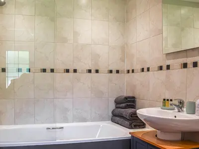 a bathroom with a sink and a bath tub at The Bothy - Uk33692 in Bicton