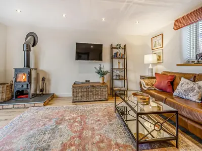 a living room with a couch and a wood stove at Pheasants Folly - Uk33955 in Llanymynech
