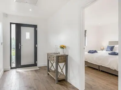 a bedroom with a bed and a table with a night stand at Oak Tree Lodge - Uk38383 in Lyonshall