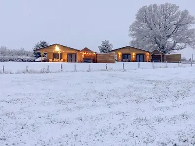 a house in a field in the snow at Oak Tree Lodge - Uk38383 in Lyonshall