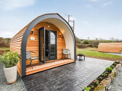 a dome house with two chairs and a patio at Celyn Bach - Uk37083 in Llanwddyn
