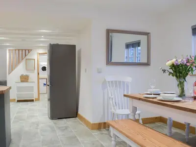 a kitchen with a stainless steel refrigerator and a table at Middle Hanter - Uk37355 in Old Radnor