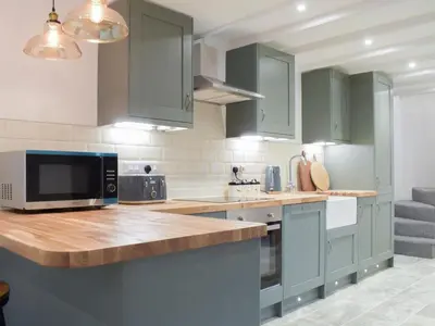 a kitchen with green cabinets and a counter top at Middle Hanter - Uk37355 in Old Radnor