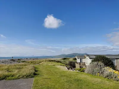 a house and a road next to a house at Sea and Mountain view Sunbeach Holiday Snowdonia in Llwyngwril