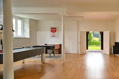 a living room with a ping pong table in it at Finest Retreats - Luxury Converted Chapel with Hot Tub & Games Room in Dinas Mawddwy