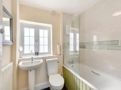 a bathroom with a toilet and a sink and a shower at The Cottage-Uk37339 in Montgomery