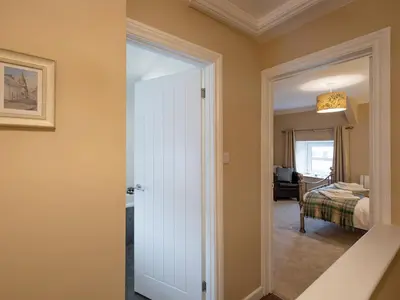 a door leading into a room with a bedroom at Y Bwthyn in Llanrhystyd