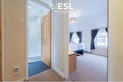 a bedroom with a bed and a bathroom with a tub at Town Centre Cosy 1 Bedroom Cottage in the Heart of Shrewsbury in Shrewsbury