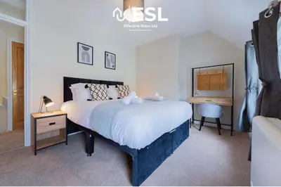 a bedroom with a large bed and a desk at Town Centre Cosy 1 Bedroom Cottage in the Heart of Shrewsbury in Shrewsbury