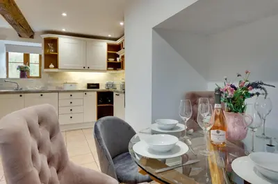 a dining room with a glass table and chairs at 3 Bed in Machynlleth oc-bow321 in Cemmaes