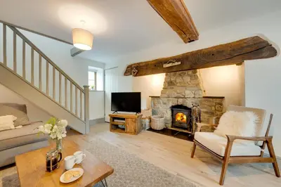 a living room with a fireplace and a couch at 3 Bed in Machynlleth oc-bow321 in Cemmaes