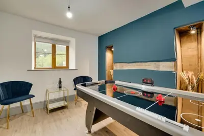 a room with a ping pong table and blue walls at 3 Bed in Machynlleth oc-bow321 in Cemmaes