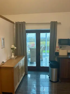 a room with a sliding glass door with a patio at The Calf Suite in Aberystwyth