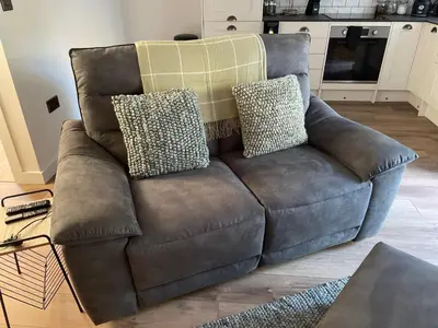 a brown couch with two pillows on it in a living room at A cottage for two in Brecon