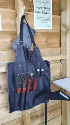 a blue bag with a bunch of tools in it at Calon Y Goedwig Glamping in Llandovery