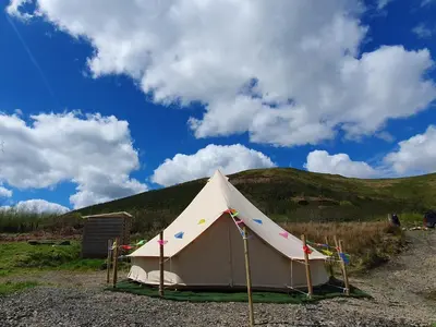 a white tent sitting on top of a hill at Calon Y Goedwig Glamping in Llandovery
