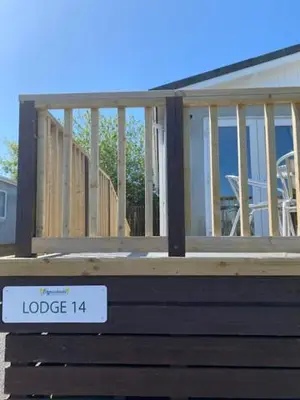 a house under construction with a sign on a bench at Lodges at Bryncarnedd, Aberystwyth in Aberystwyth