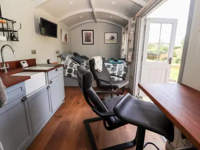 a kitchen and dining room of a tiny house at The Moorhen Retreat in Oswestry