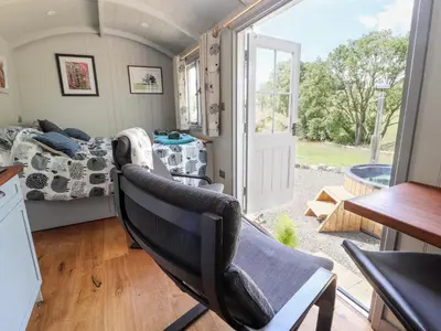 a small room with a bed and a window at The Moorhen Retreat in Oswestry