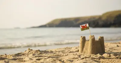 a sand castle with a flag on the beach at 2 Bed in Aberaeron oc-bow329 in Aberaeron