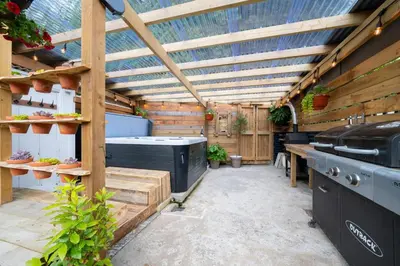 a greenhouse with a hot tub and a stove at 2 Bed in Aberaeron oc-bow329 in Aberaeron