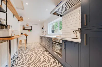 a kitchen with blue cabinets and a sink at 2 Bed in Aberaeron oc-bow329 in Aberaeron