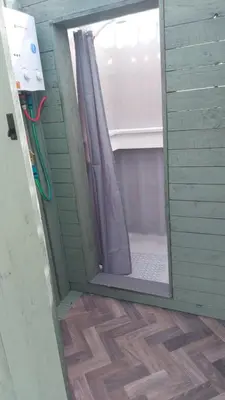 a door to a bathroom with a shower in a room at Yurt Uchaf Off-Grid Glamping in Machynlleth