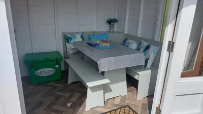 a table in a room with a green trash can at Yurt Uchaf Off-Grid Glamping in Machynlleth