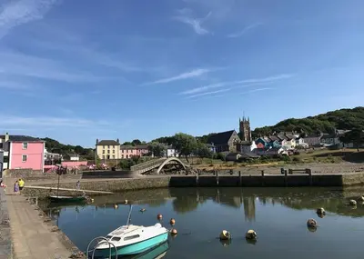 a boat is docked in a body of water at Seven Springs in Llanon