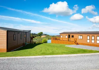 a home with a large yard and a house at Seven Springs in Llanon