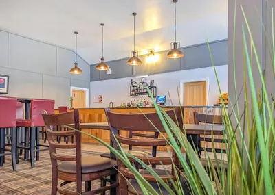 a dining room with a table and chairs at The Warrens At Foxtail in Chirk