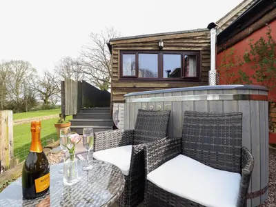 a bottle of wine sitting on a table with a glass at The Retreat in Oswestry