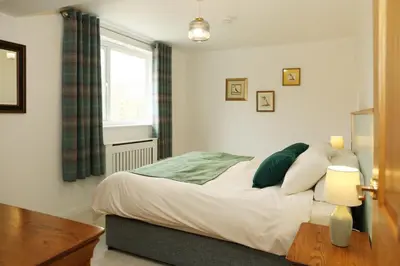 a bedroom with a bed and a window at Woodpecker Way at Eaton Manor in Eaton
