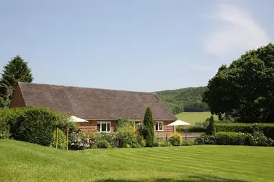 a house with a large lawn in front of it at Woodpecker Way at Eaton Manor in Eaton