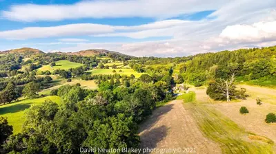 an aerial view of the rolling hills and trees at MotoCamp Wales - Lodges in Dolgellau