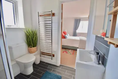 a small bathroom with a toilet and a sink at Ty Ni in New Quay