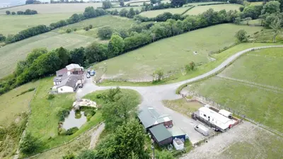 an aerial view of a farm with a house and trailer at Pant yr onen holidays in Llandrindod Wells