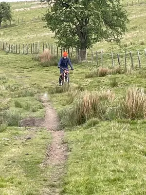 a person riding a bike down a dirt road at Pant yr onen holidays in Llandrindod Wells