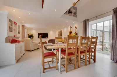 a dining room and living room with a table and chairs at 4 Bed in Aberystwyth oc-bow304 in Rhostie