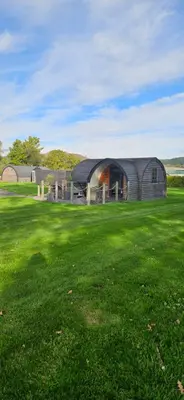 a large building in a field of green grass at EASTRIDGE GLAMPING in Shrewsbury