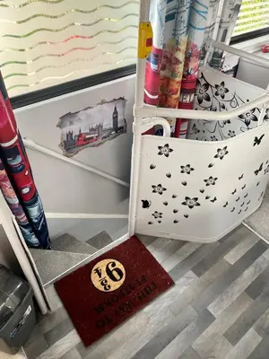 a drawer in a refrigerator with a rug in the floor at Double Decker Bus in Aberystwyth
