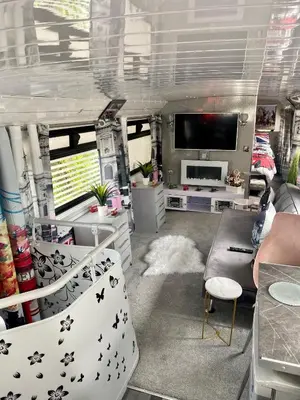 a living room with a couch and a tv at Double Decker Bus in Aberystwyth