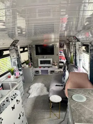 an rv living room with a tv and a couch at Double Decker Bus in Aberystwyth