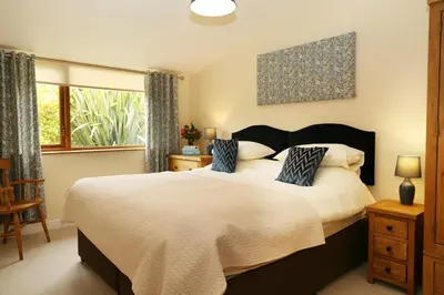 a bedroom with a large bed and a window at Great Western Lodge at Eaton Manor in Eaton