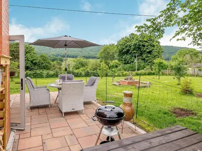 a patio with a bbq and a grill at Violet Cottage in Hereford
