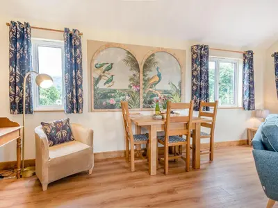 a dining room with a table and chairs at Violet Cottage in Hereford