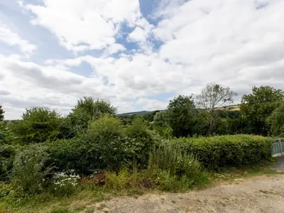 a field of bushes and trees with a cloudy sky at Cosy cottage with views over the Shropshire hills - Pass the Keys in Ludlow