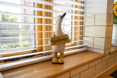 a stuffed goat sitting on a window sill with a welcome sign at Apple Tree Cottage - Cosy 2 Bed with Deluxe HOT TUB & Log Burner in Hereford